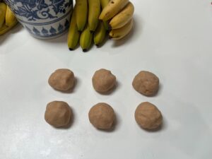 Homemade Play-Dough divided into 6 balls ready for colouring